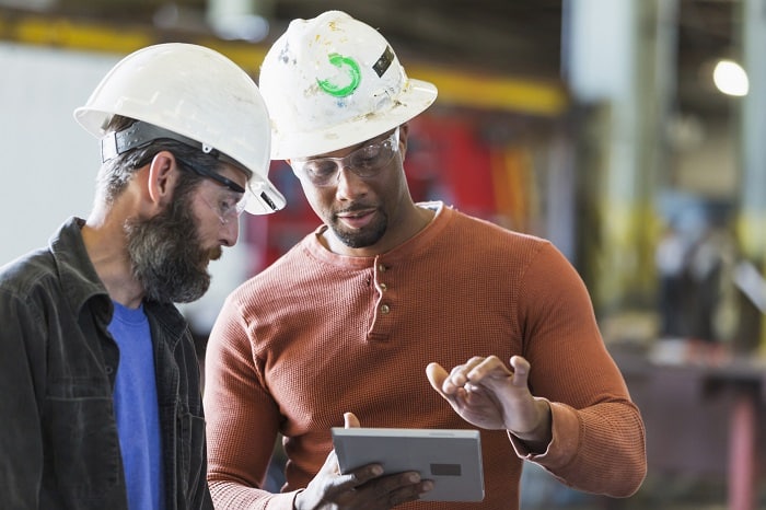 Two workers with a digital tablet