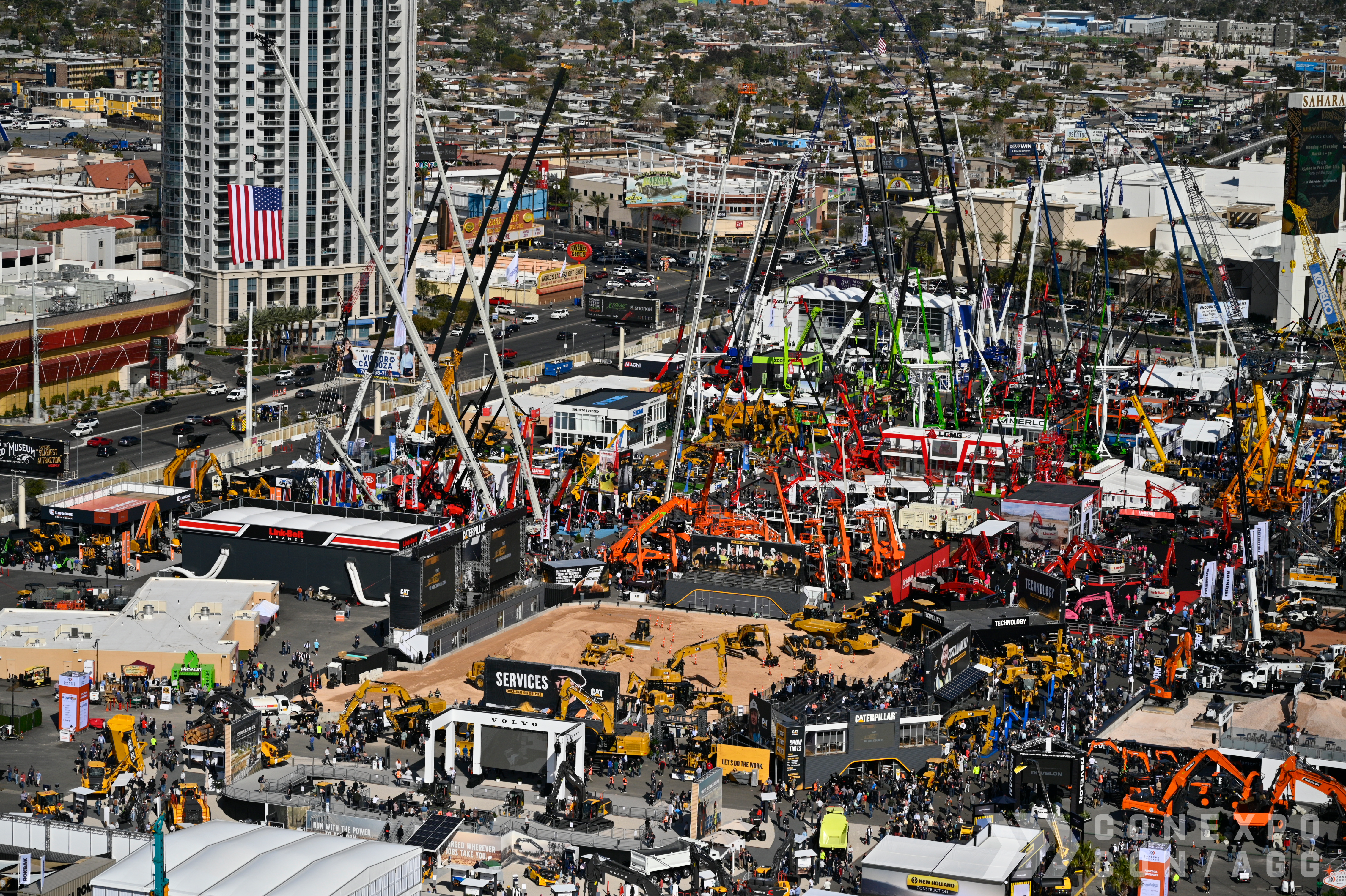 Aerial view of the modern CONEXPO-CON/AGG construction trade show in Las Vegas with cranes and heavy machinery.