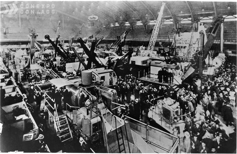Historic construction equipment exhibition with large crowd in an indoor trade hall at CONEXPO-CON/AGG